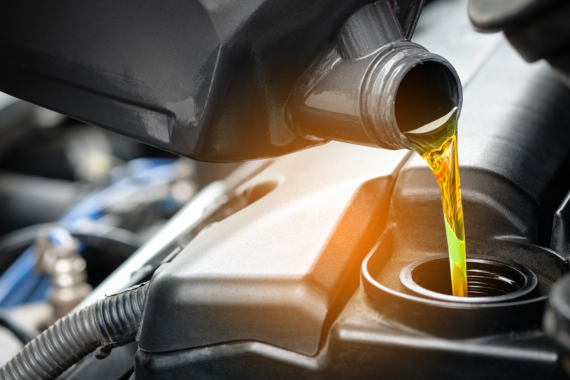 Refueling and pouring oil quality into the engine motor car Transmission and Maintenance Gear.Energy fuel concept Refueling and pouring oil quality into the engine motor car Transmission and Maintenance Gear.Energy fuel concept