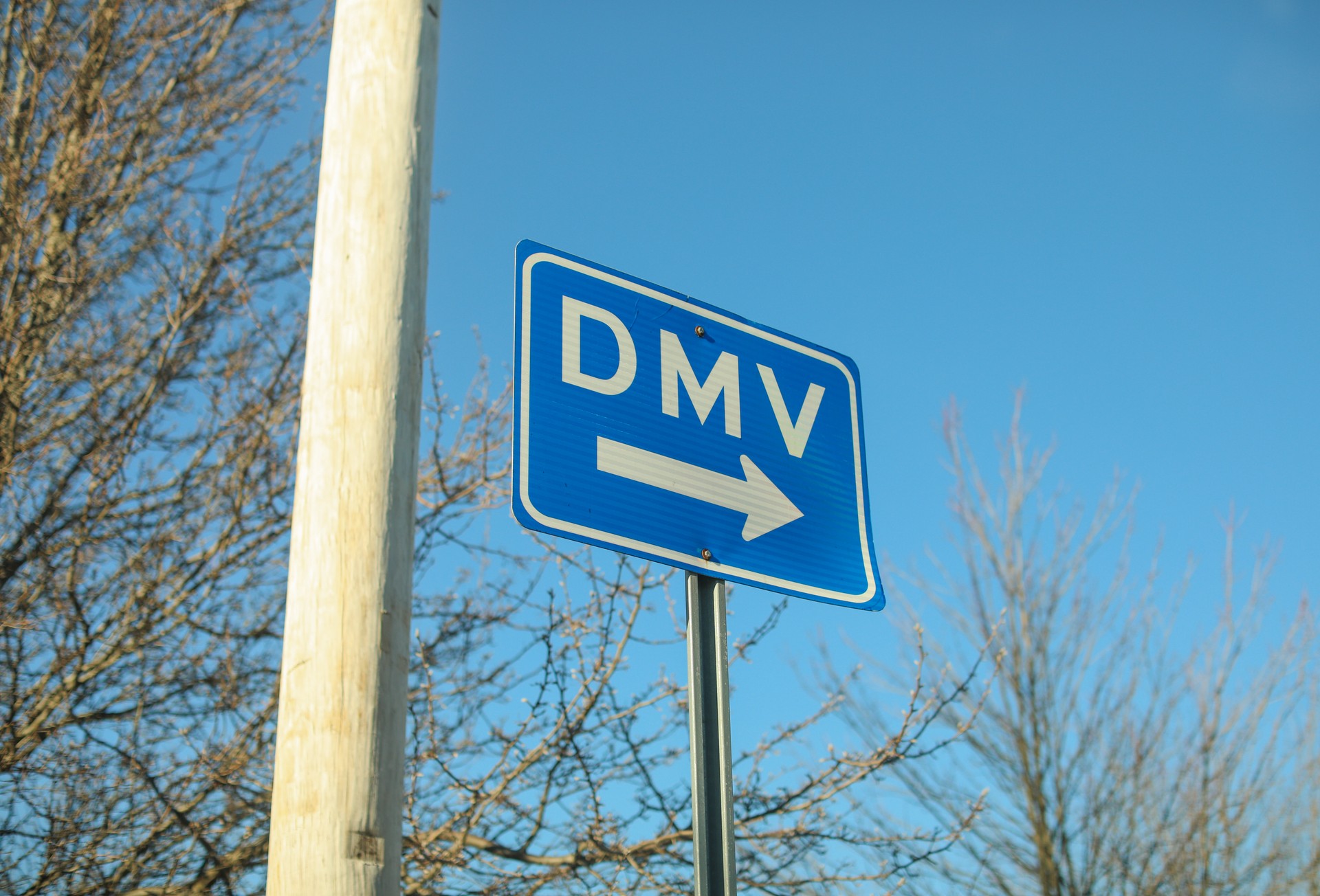 DMV sign street showing where to get drivers registration DMV sign street showing where to get drivers registration